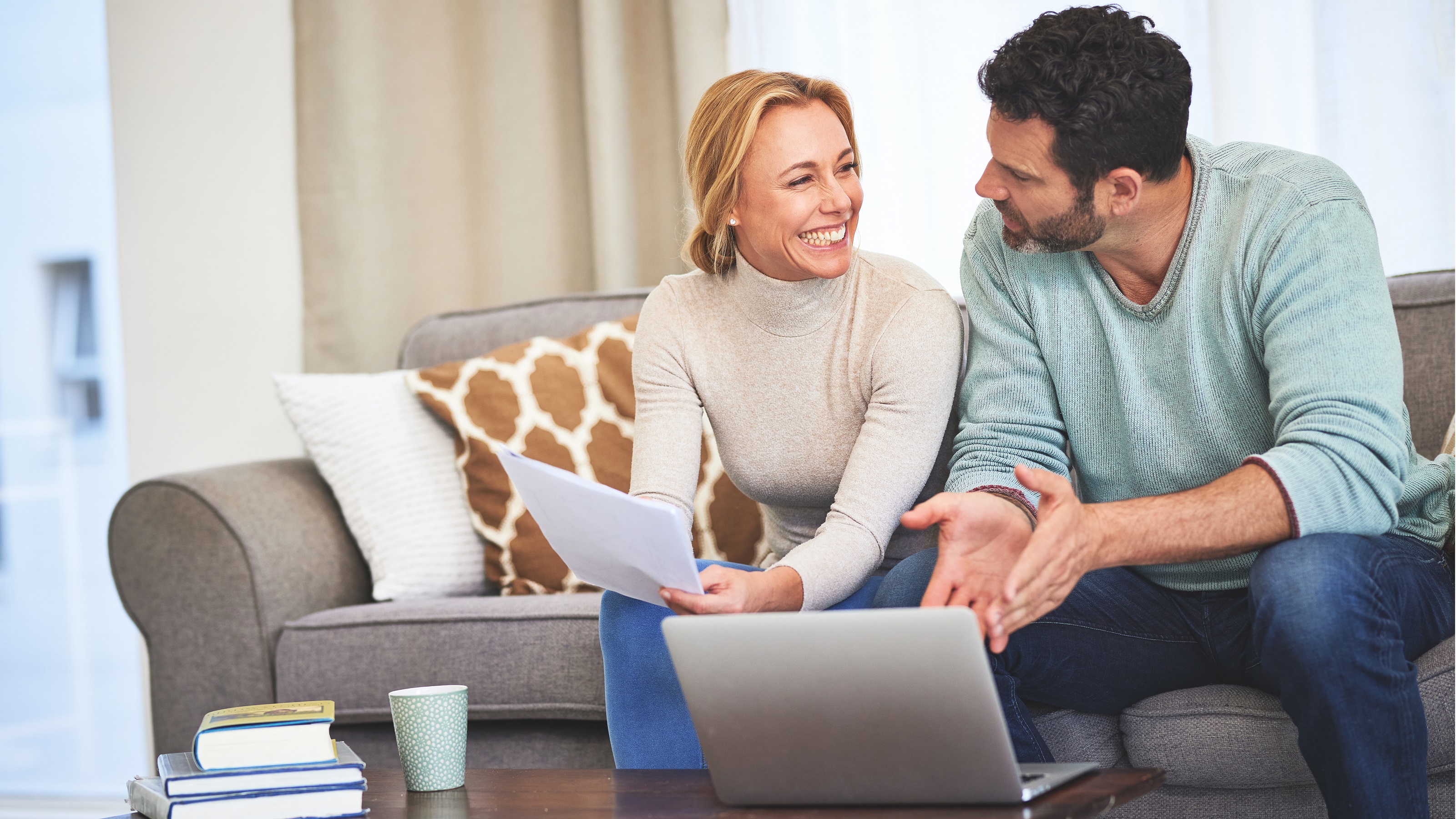 Elderly couple reviewing retirement planning documents and financial statements